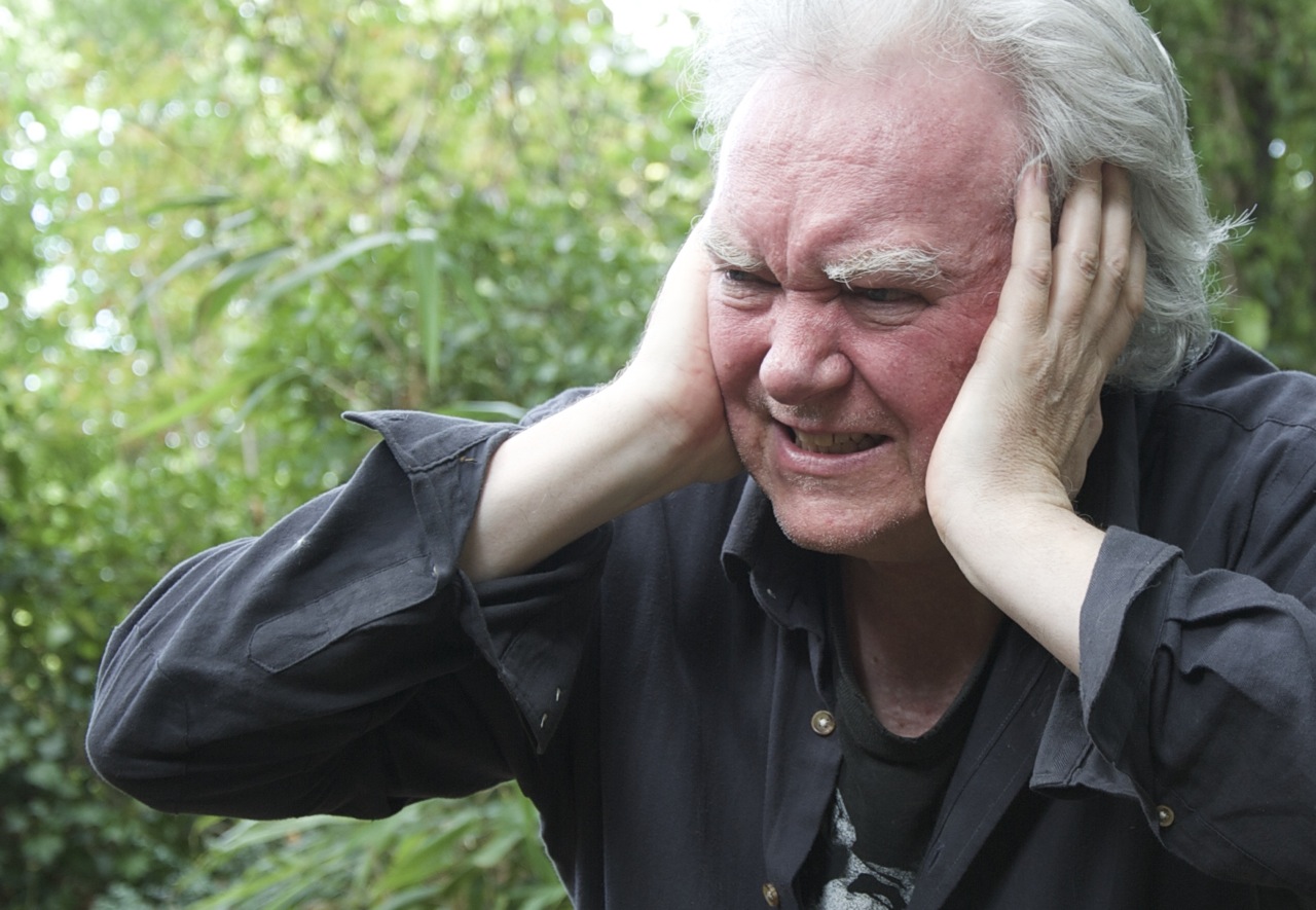 Billy Jenkins covering his ears photographed by Beowulf Mayfield