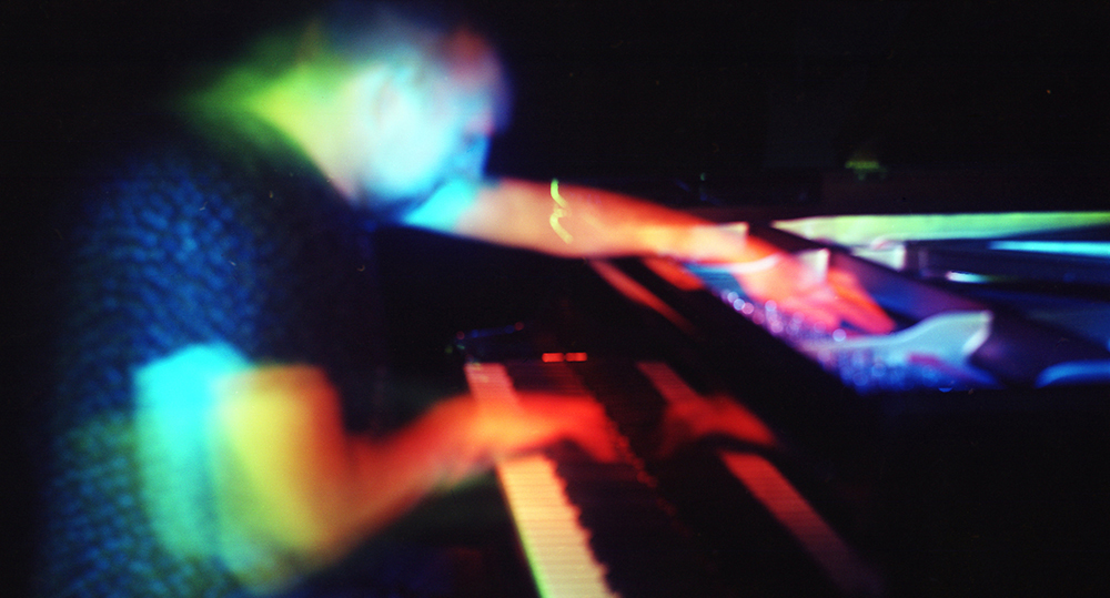 Light painted image of piano player Huw Warren by Beowulf Mayfield