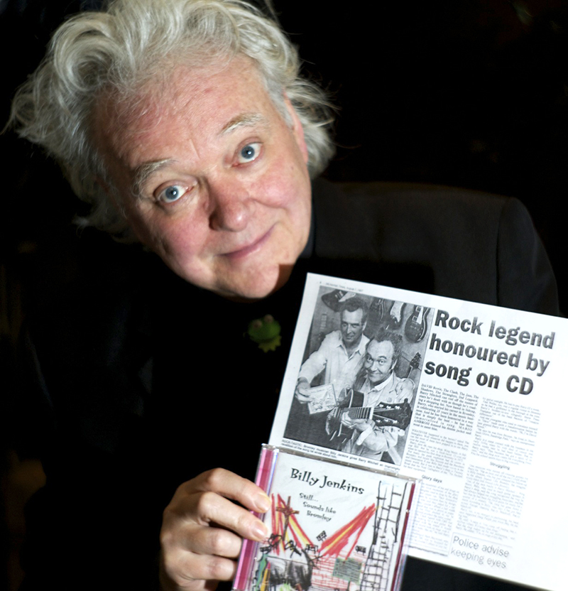 Billy Jenkins with press cutting about Barry Mitchell and Wing Music, photographed by Beowulf Mayfield