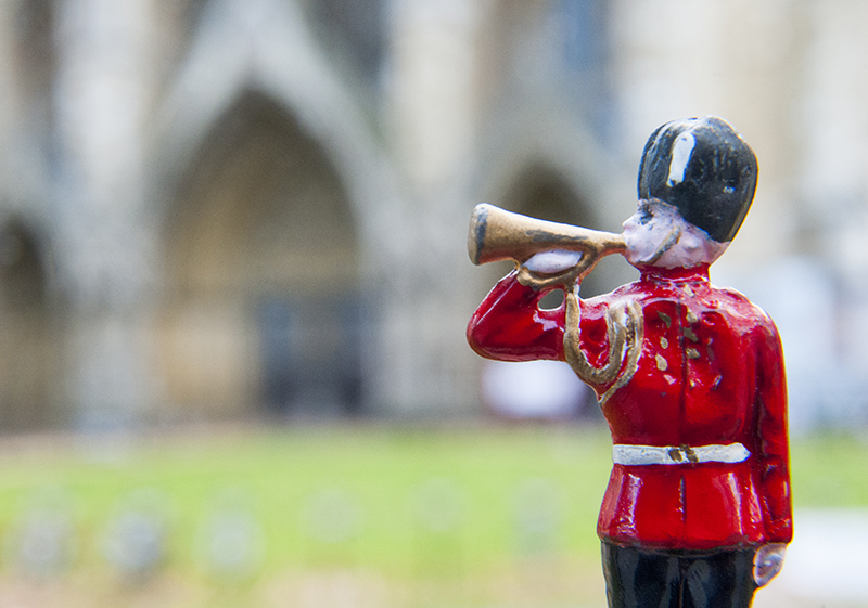 Lead soldier playing the bugle outside the North Door of London's Westminster Abbey